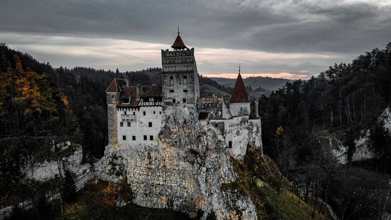 Bran Castle rising above the forested cliffs of the Bran pass