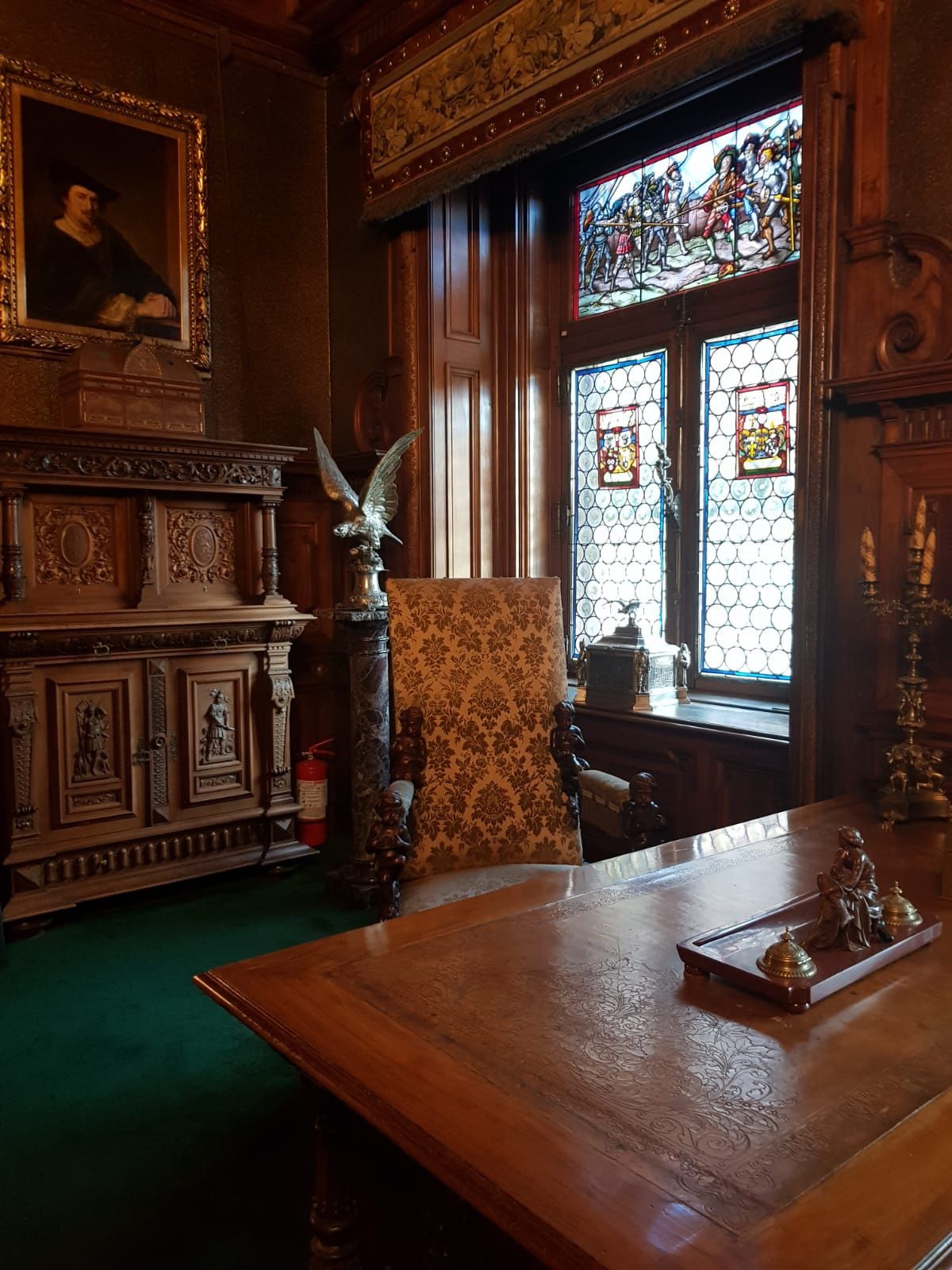 Intricate wood-paneled hall inside Peleș Castle