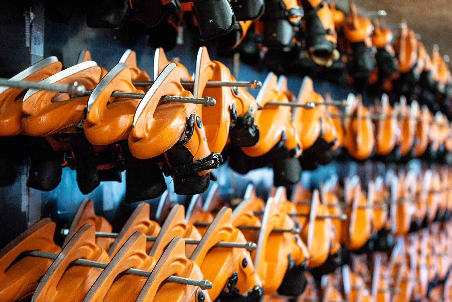 Rows of rental ice skates on a rack
