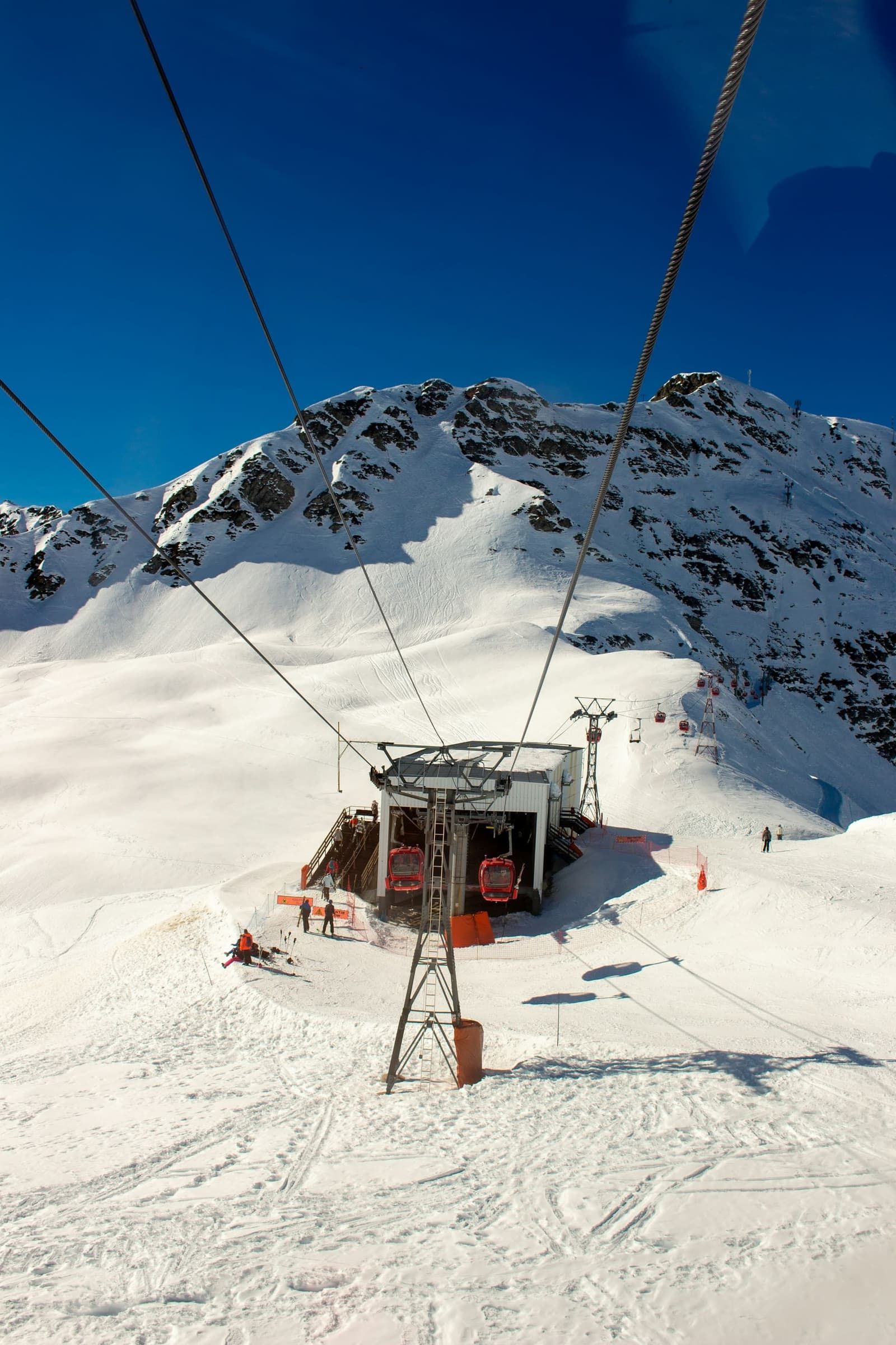 A gondola cabin above snowy fir forest on the way up to the Bucegi plateau at Sinaia
